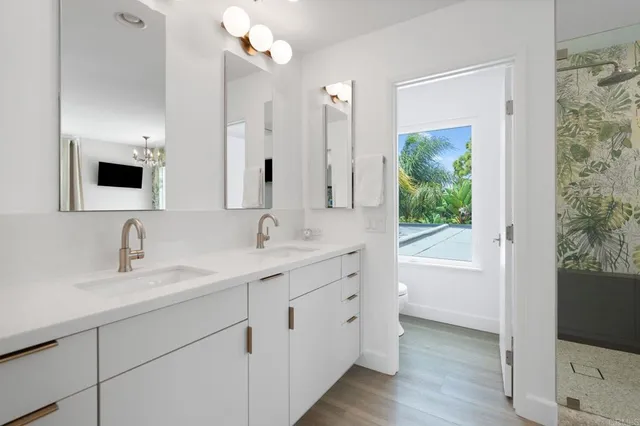 a bathroom with a double vanity sink and a mirror