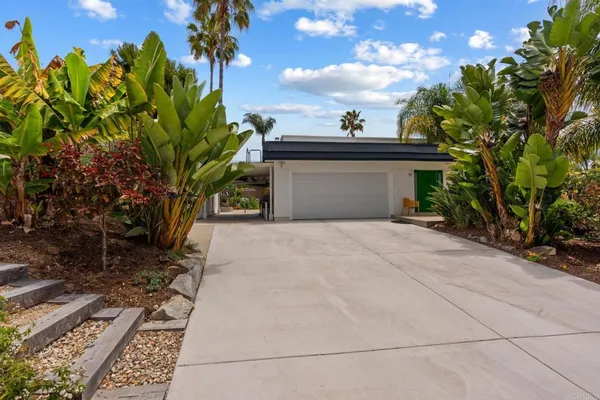 a backyard of a house with table and chairs