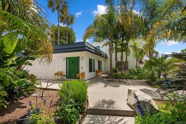 a living room with furniture a desk and chair with wooden floor