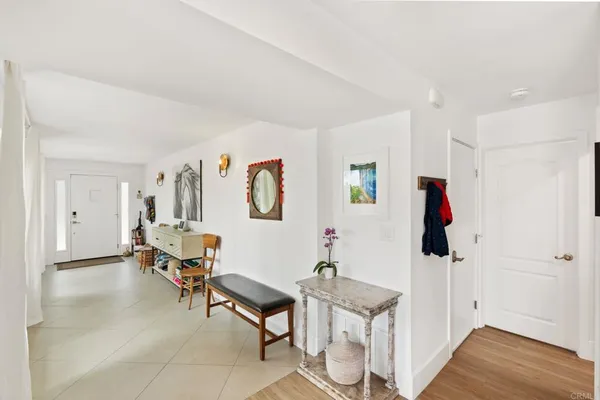 a living room with furniture a flat screen tv and a window