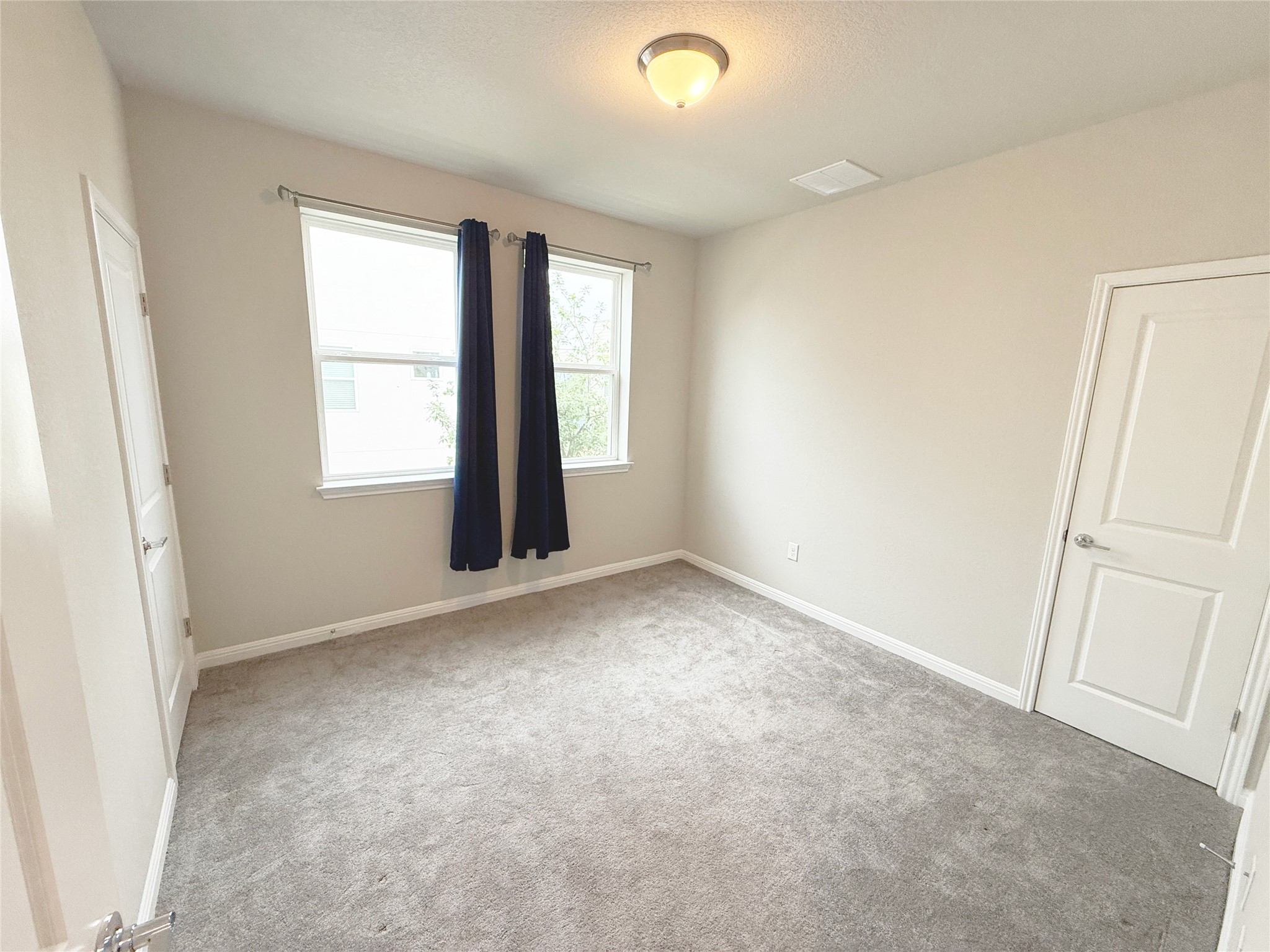 9015 Cattle Baron Path, Unit 605 Austin, TX 78747 - Photo 5 of 20 Unfurnished bedroom 3 with carpet floors and baseboards