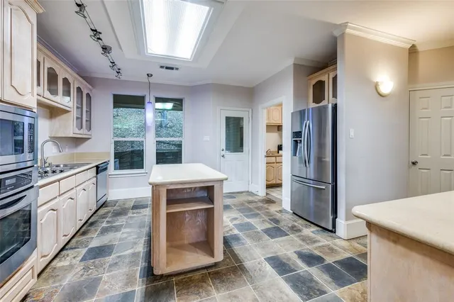 a kitchen with stainless steel appliances granite countertop a sink and cabinets