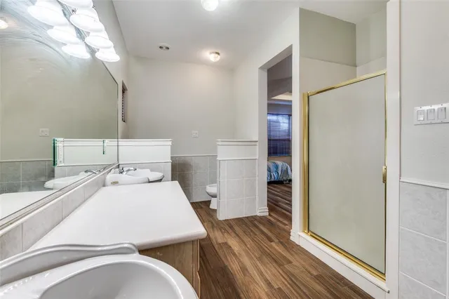 a bathroom with a tub sink and mirror