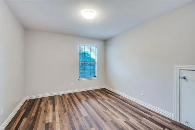 a view of a livingroom with a hall and wooden floor