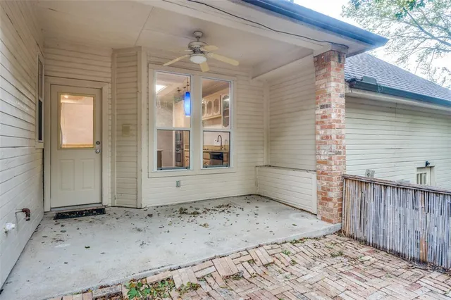 a view of a backyard with wooden fence