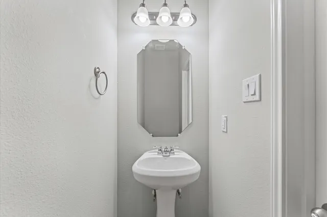 an empty room with a window and a ceiling fan