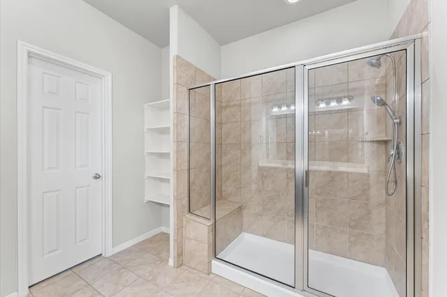 a spacious bathroom with a shower and a sink