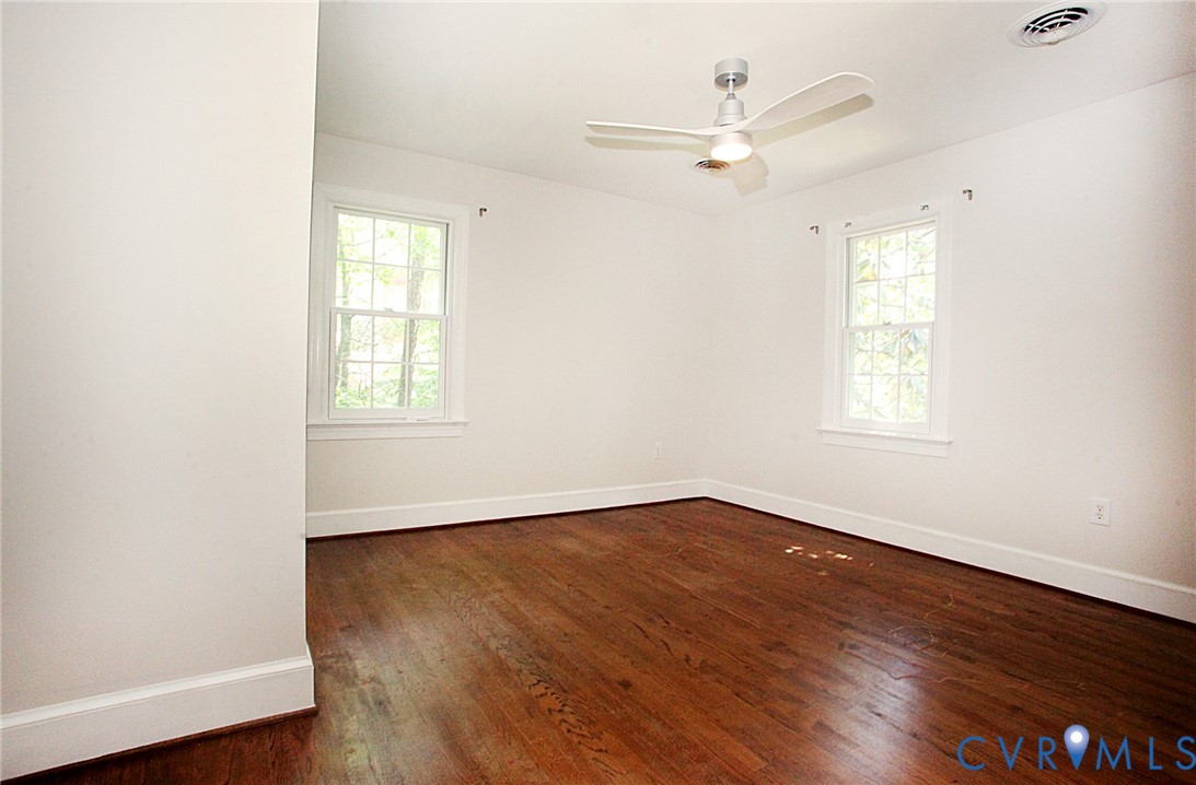 231 Hazelmere Drive Chesterfield, VA 23236 - Photo 23 of 33 an empty room with wooden floor fan and windows