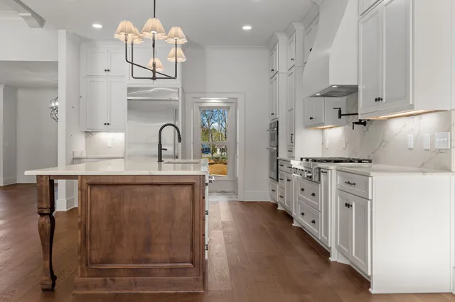 a room with walk in closet and wooden floor