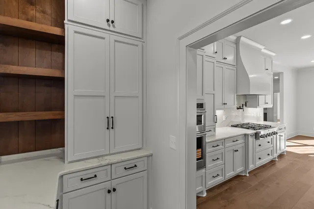 a bathroom with a double vanity sink a mirror and a bathtub
