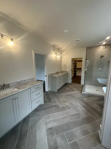 a large bathroom with a sink and a large mirror