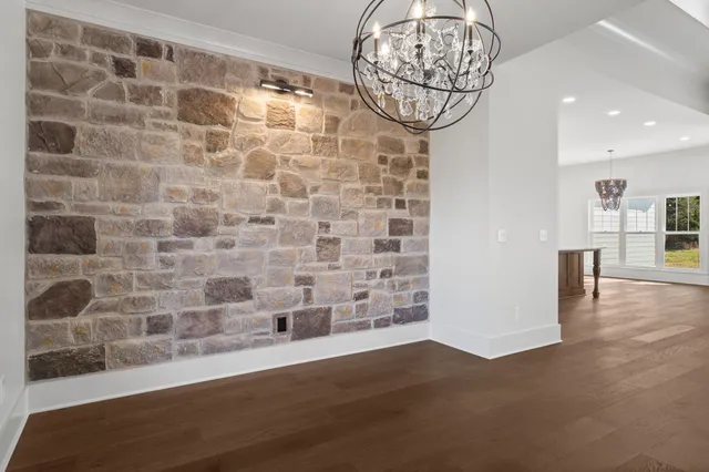 a view of an empty room with a fireplace and a window