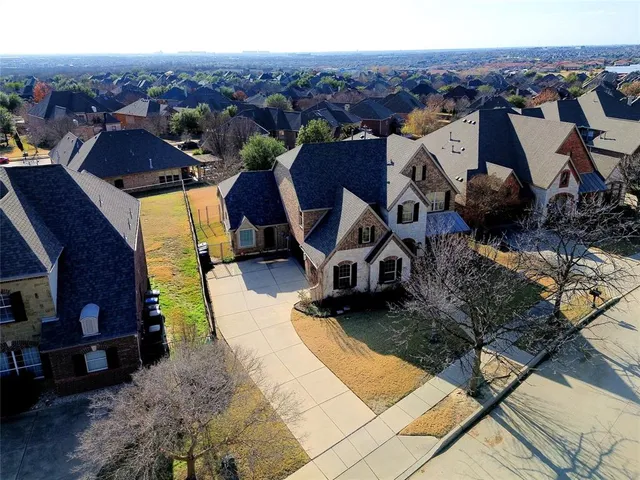 an aerial view of a houses with a city view