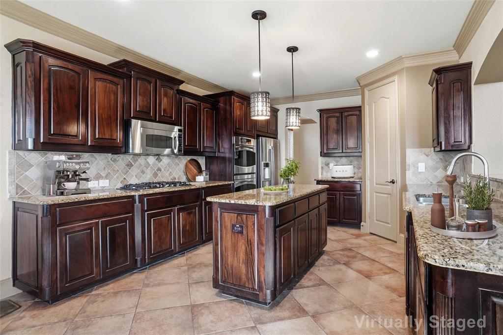 4840 Exposition Way Fort Worth, TX 76244 - Photo 9 of 40 a kitchen with kitchen island granite countertop a sink stove and cabinets