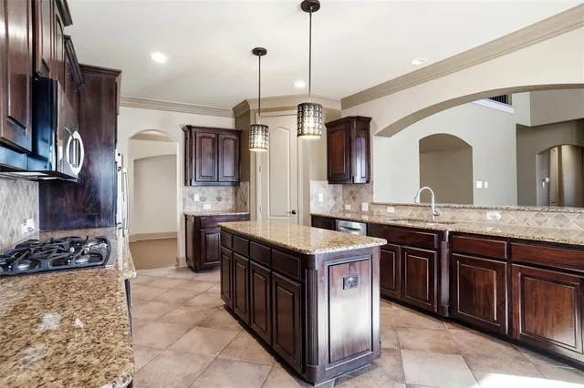 a kitchen with a sink stove and refrigerator