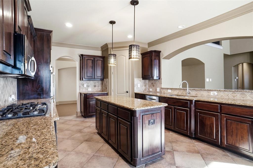 4840 Exposition Way Fort Worth, TX 76244 - Photo 10 of 40 a kitchen with a sink stove and refrigerator