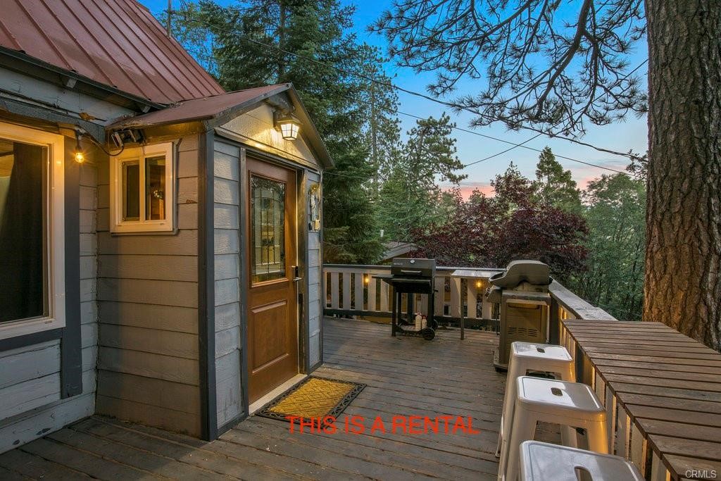 23882 Springwater Road Crestline, CA 92325 - Photo 2 of 39 a view of house with a large window and potted plants