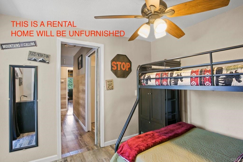 23882 Springwater Road Crestline, CA 92325 - Photo 21 of 39 a bedroom with a bed and a chandelier