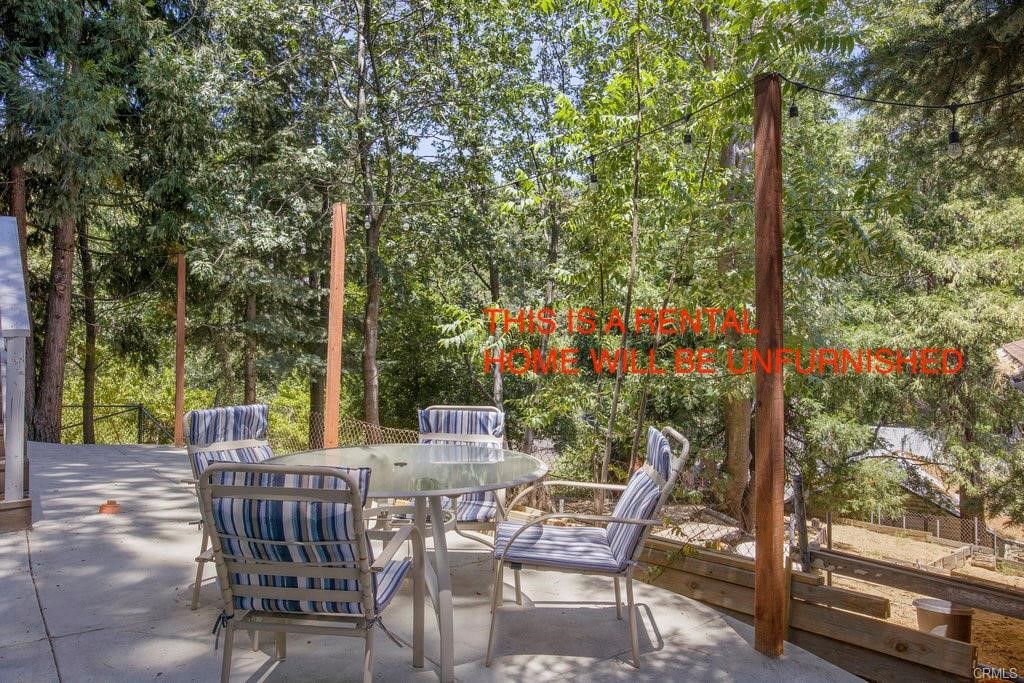 23882 Springwater Road Crestline, CA 92325 - Photo 28 of 39 a view of chairs and table in the patio