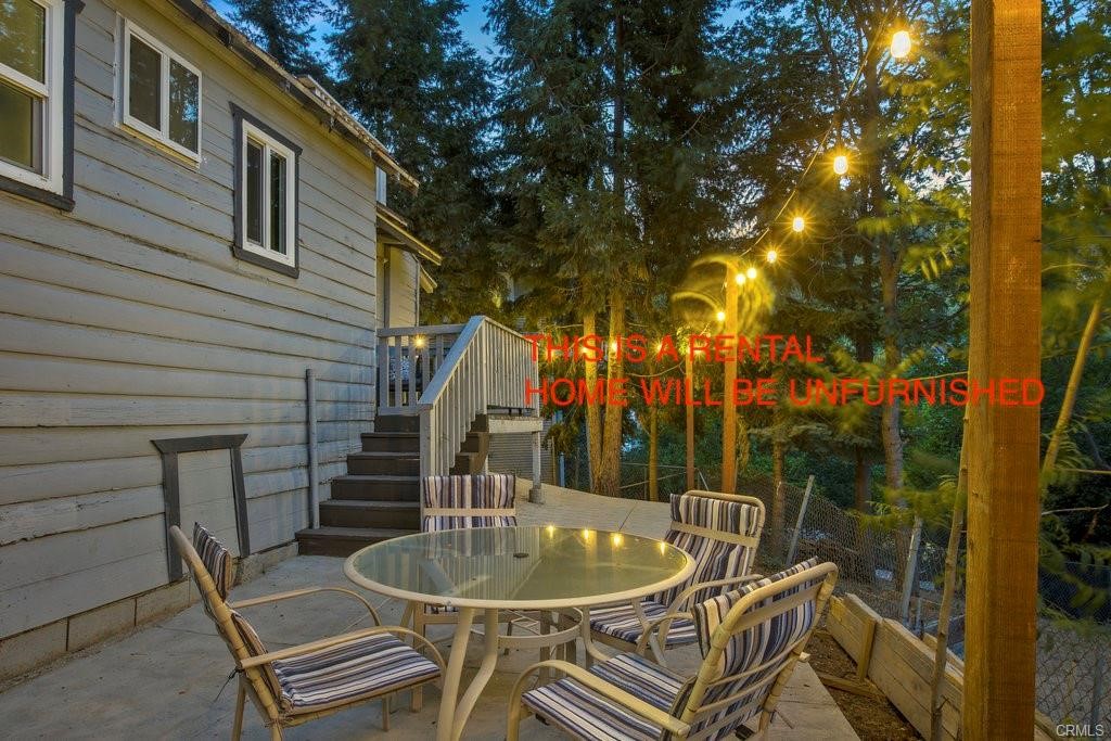 23882 Springwater Road Crestline, CA 92325 - Photo 36 of 39 a backyard of a house with table and chairs