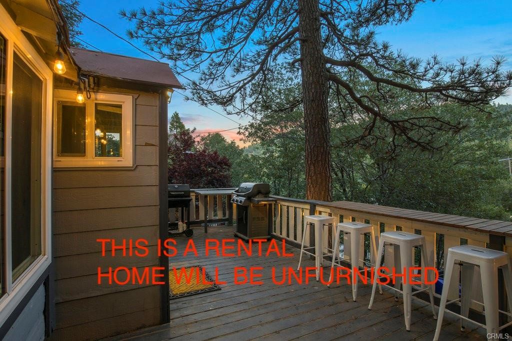 23882 Springwater Road Crestline, CA 92325 - Photo 39 of 39 a balcony with wooden floor and outdoor seating