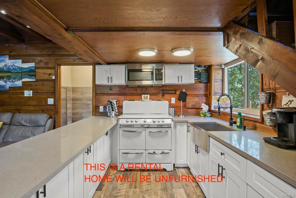 23882 Springwater Road Crestline, CA 92325 - Photo 10 of 39 a kitchen with stainless steel appliances granite countertop a sink a stove and a wooden floors
