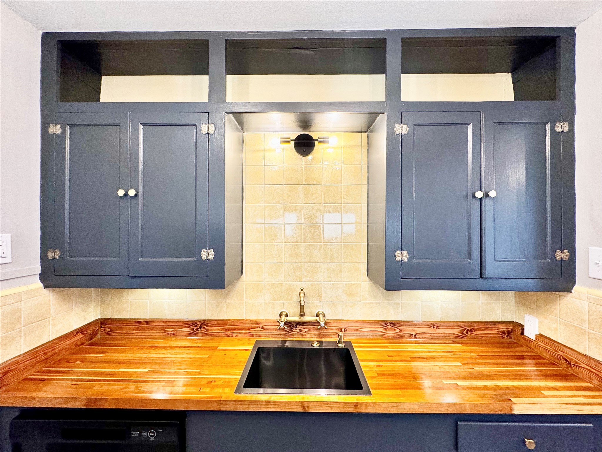 1018 Dunbar Street Houston, TX 77009 - Photo 16 of 30 Butcher-block countertops are perfectly contrasting with the dark cabinet paint and fun vintage yellow tile backsplash!