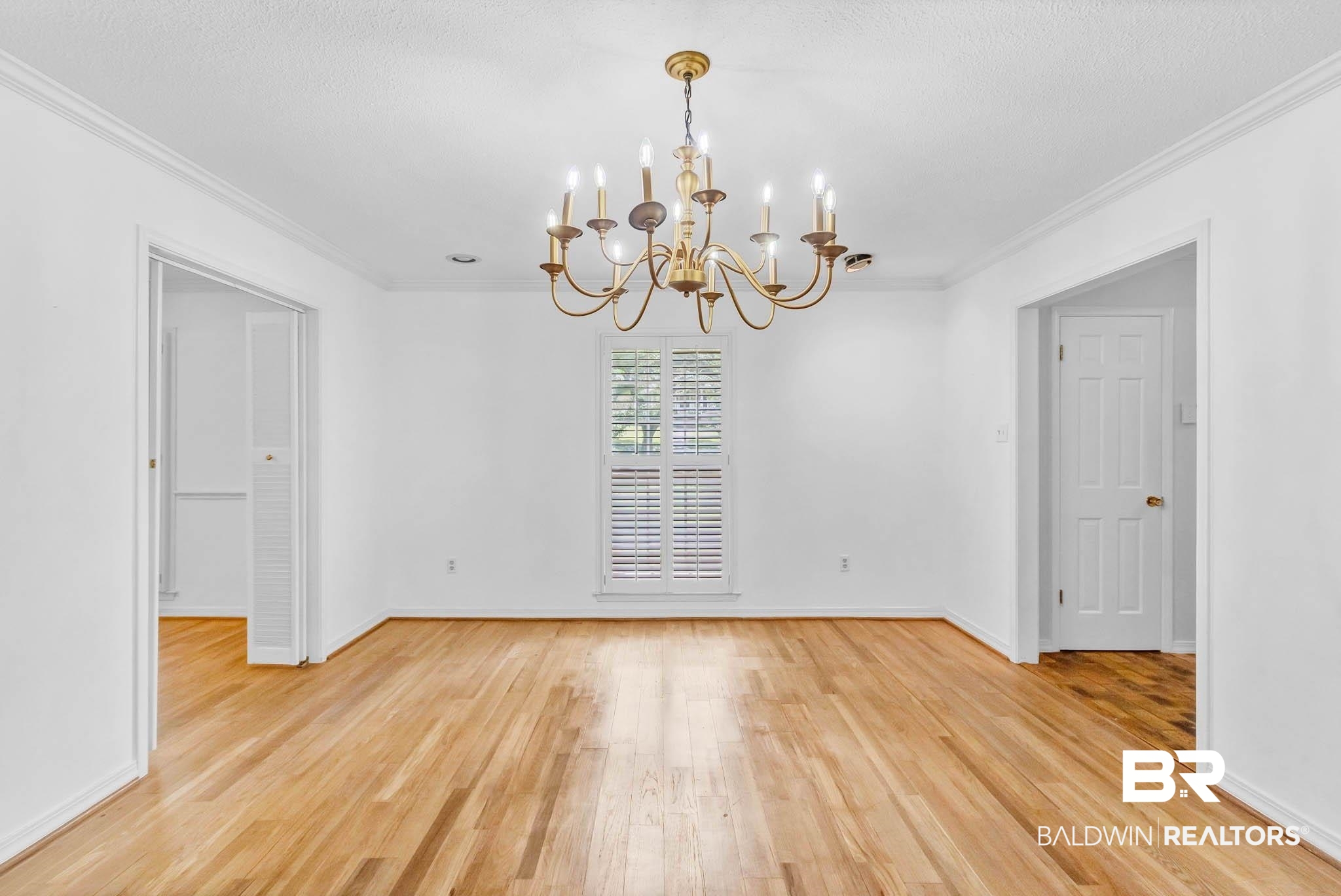 309 West Brandy Run Road Mobile, AL 36608 - Photo 29 of 100 Unfurnished dining area featuring ornamental molding, light wood-style floors, and a chandelier