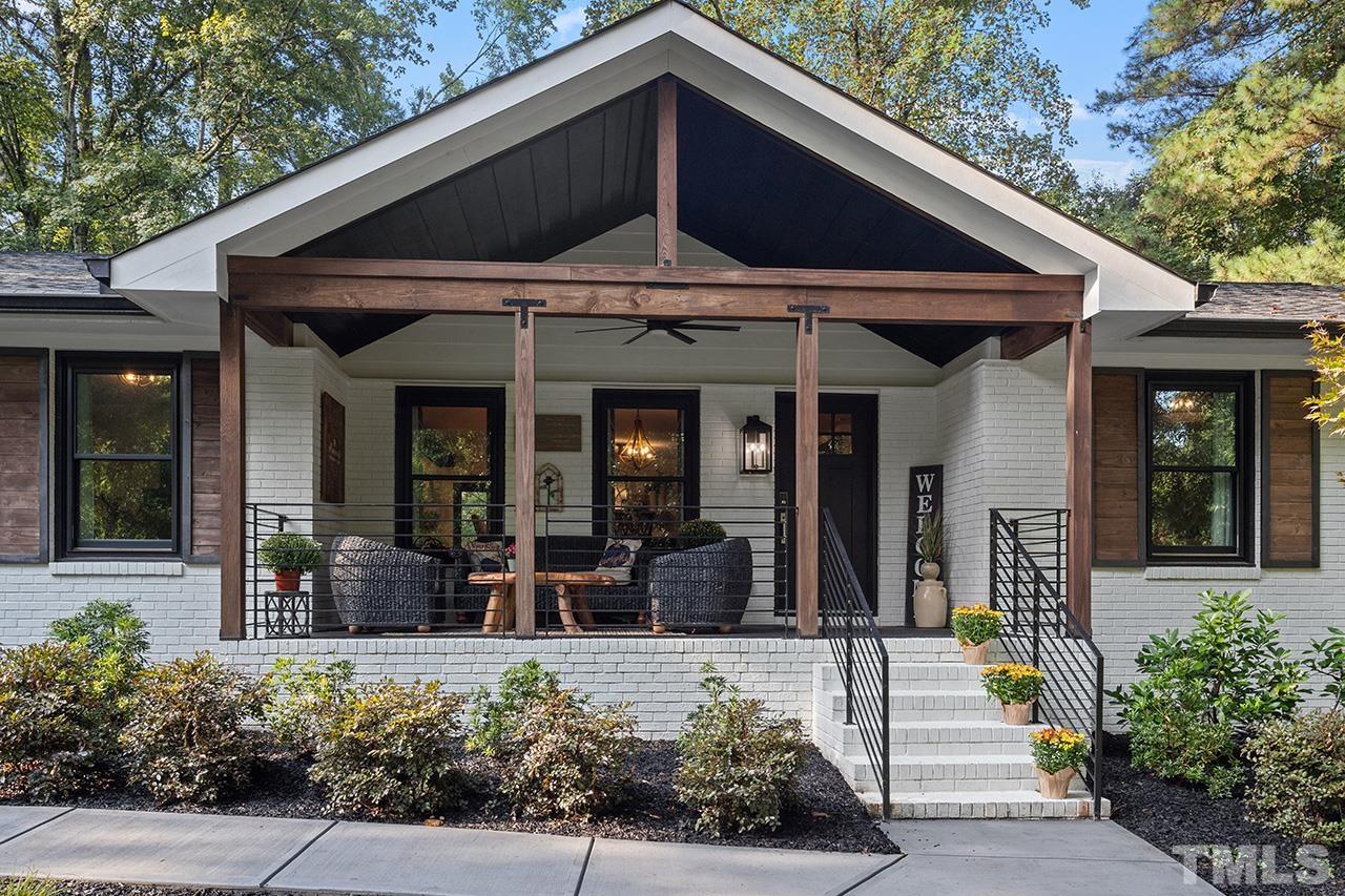 a view of a house with sitting area and potted plants