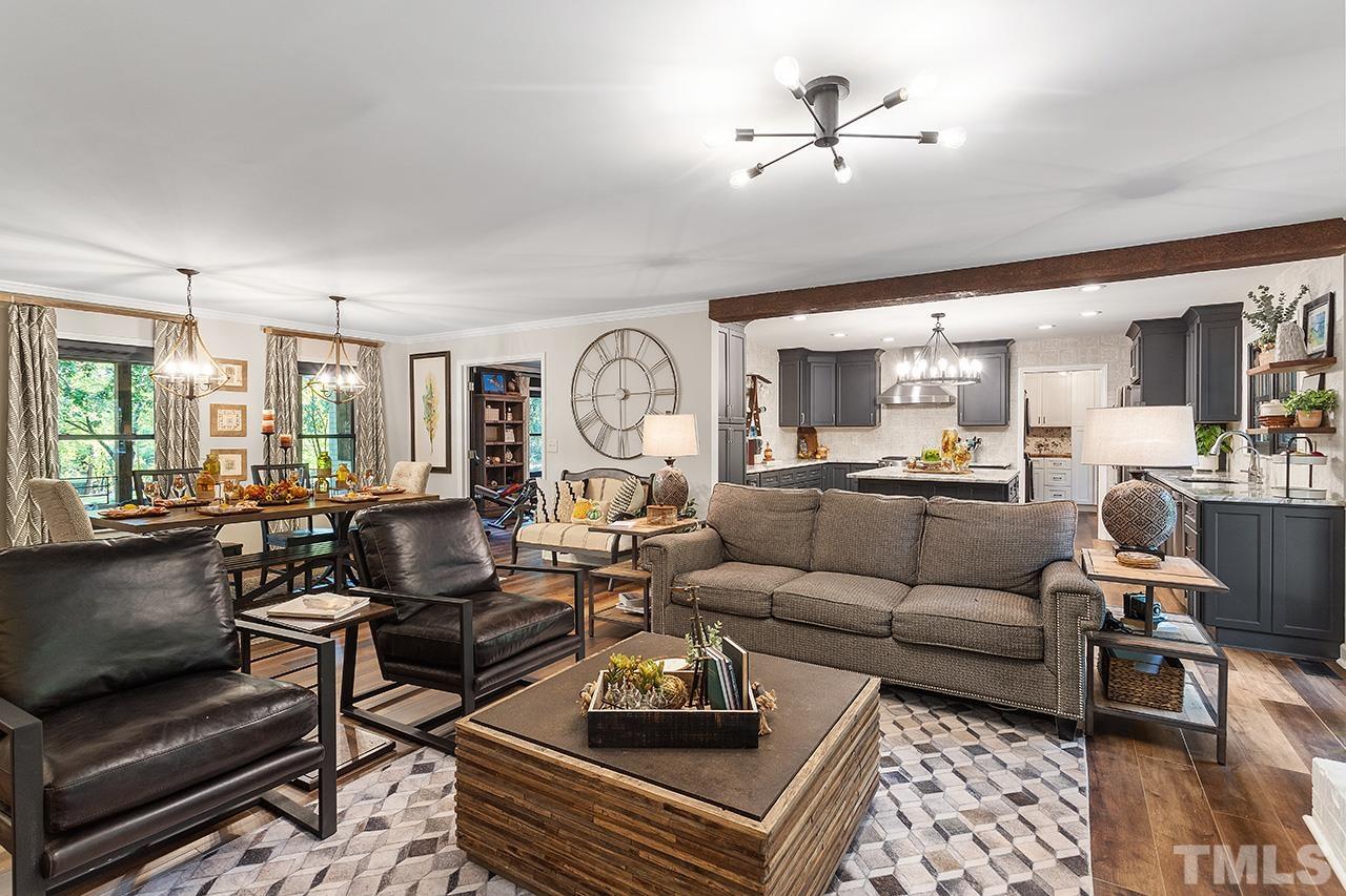 11605 Durant Road Raleigh, NC 27614 - Photo 14 of 42 a living room with furniture a rug and a chandelier