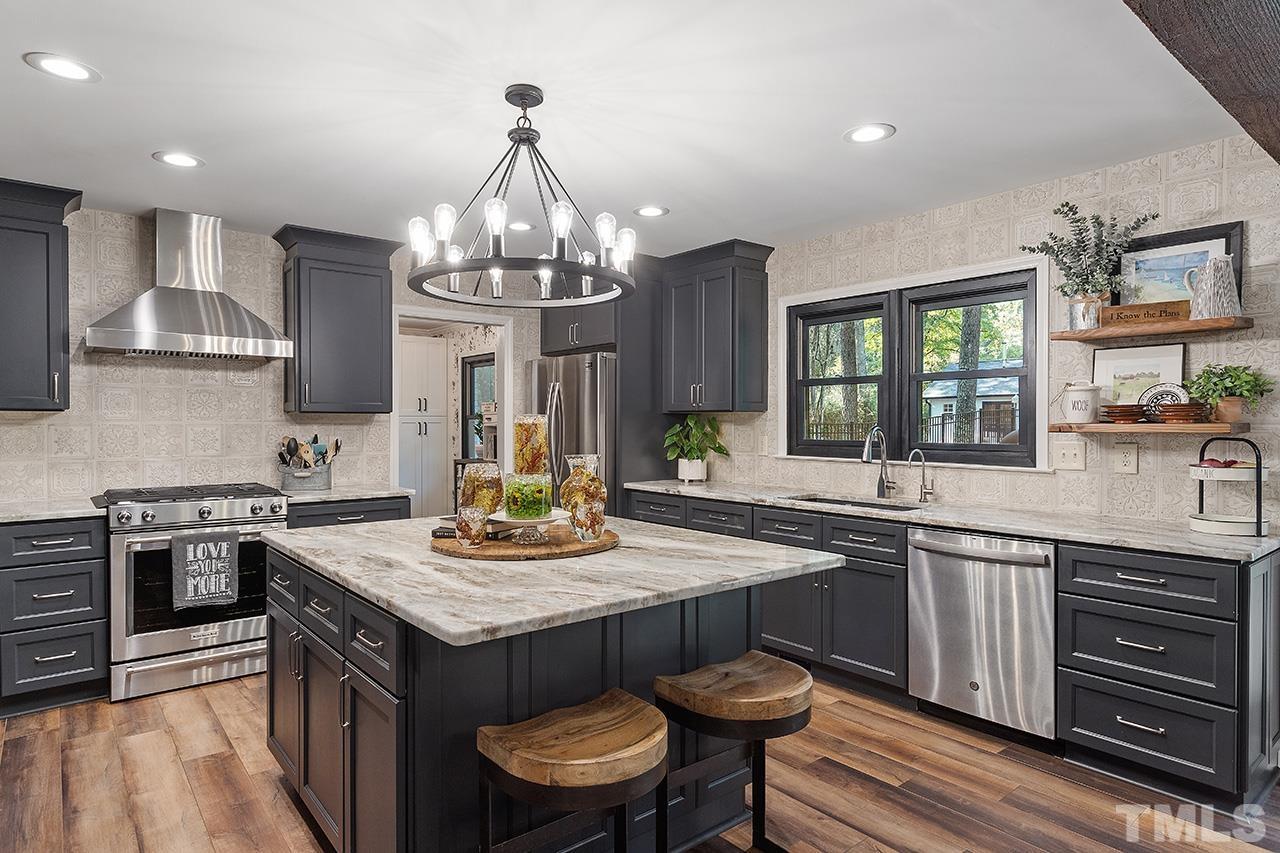 11605 Durant Road Raleigh, NC 27614 - Photo 16 of 42 a kitchen with stove a sink and cabinets