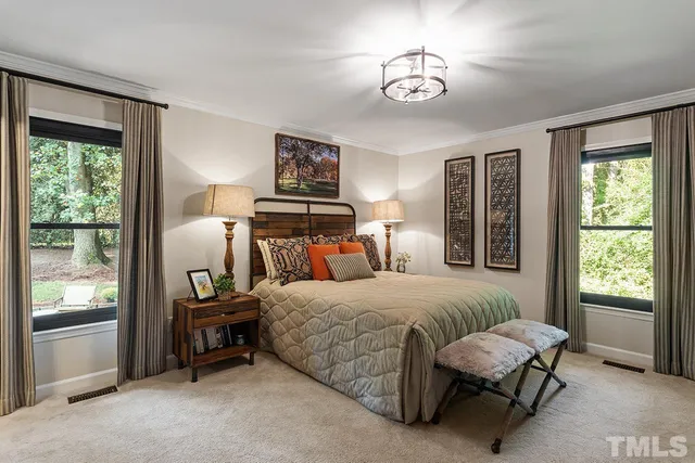 a bedroom with a bed and a chandelier