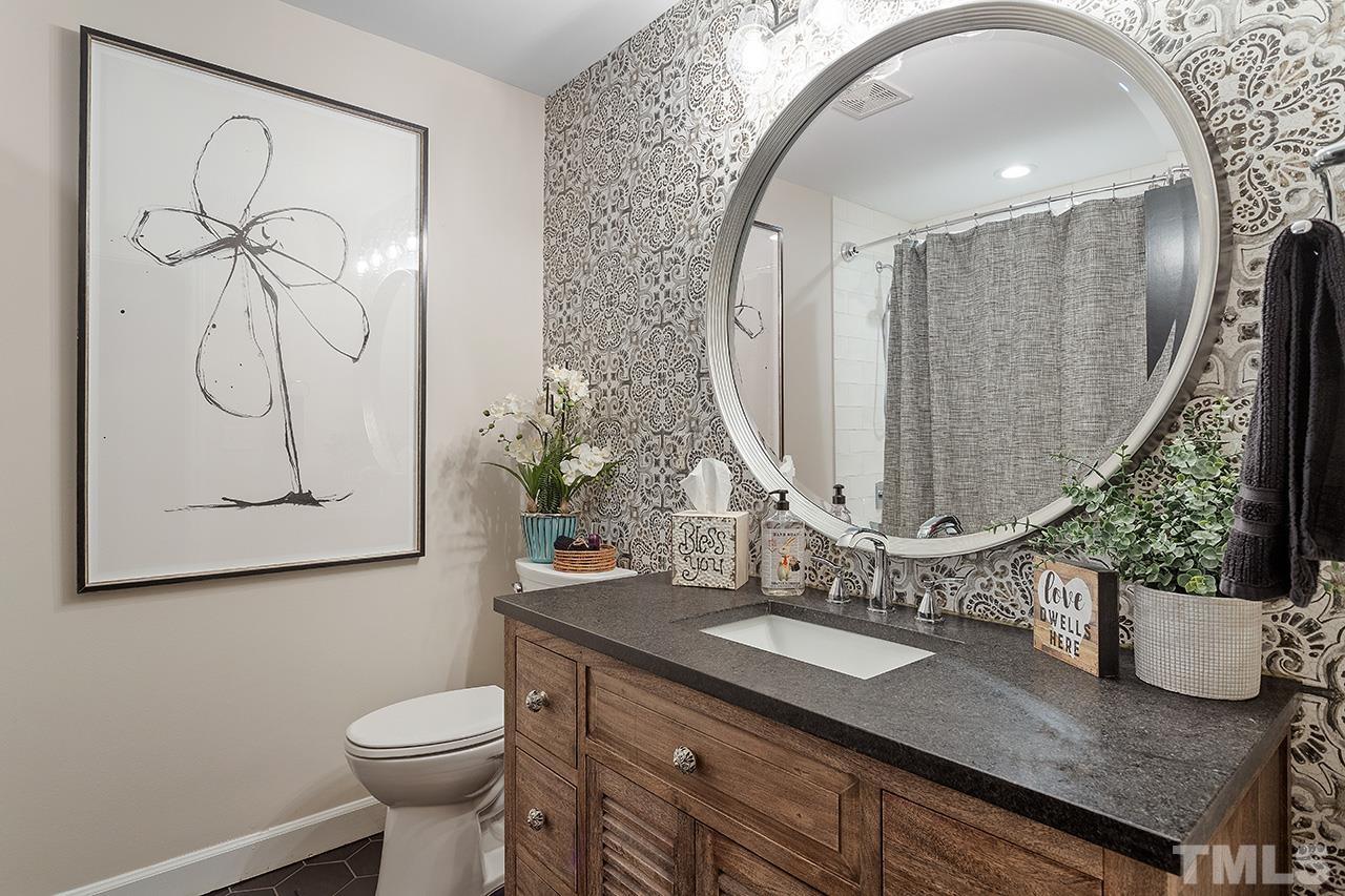 11605 Durant Road Raleigh, NC 27614 - Photo 28 of 42 a bathroom with a granite countertop sink and a mirror