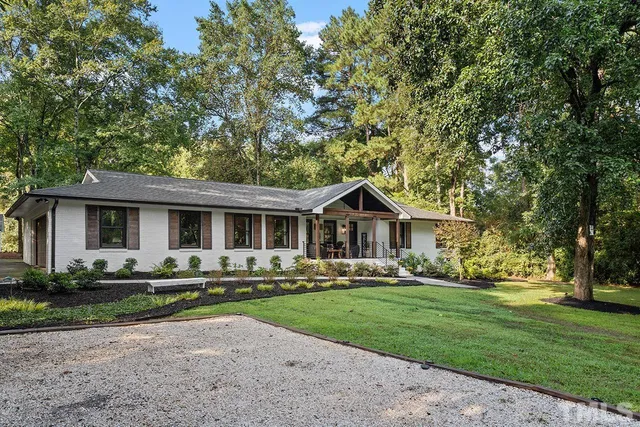 a front view of house with yard and green space