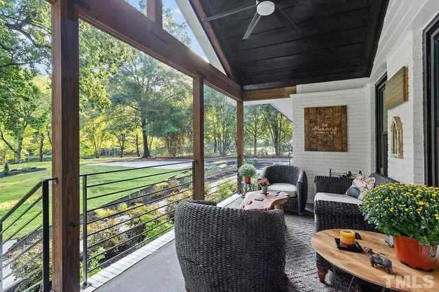 a balcony with furniture and garden view
