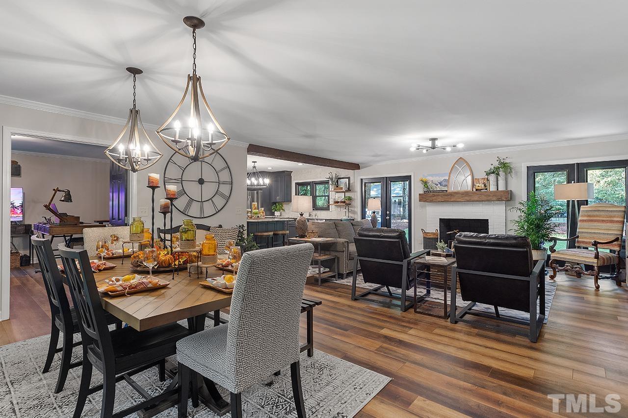 11605 Durant Road Raleigh, NC 27614 - Photo 9 of 42 a view of a dining room with furniture a chandelier and wooden floor