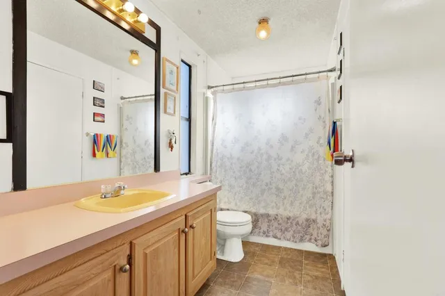 a bathroom with a sink toilet double vanity and shower