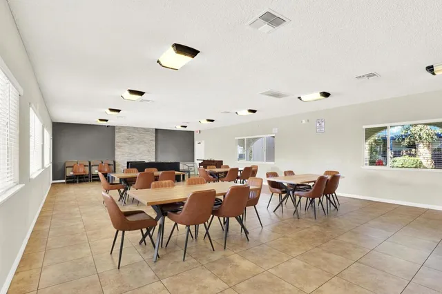 a view of a dining hall with furniture and window