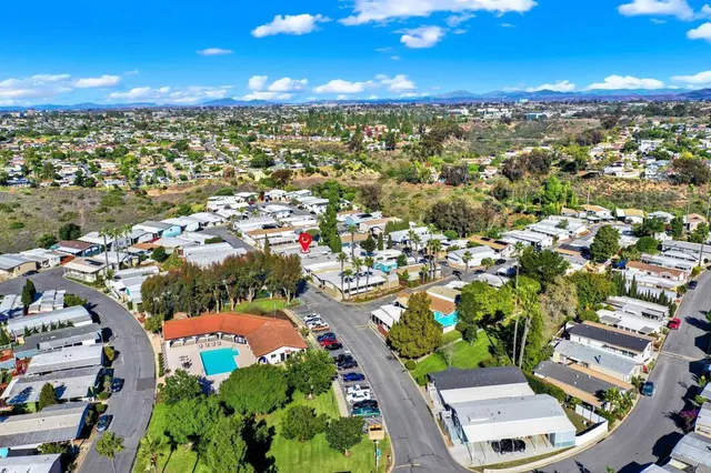 an aerial view of residential houses with outdoor space