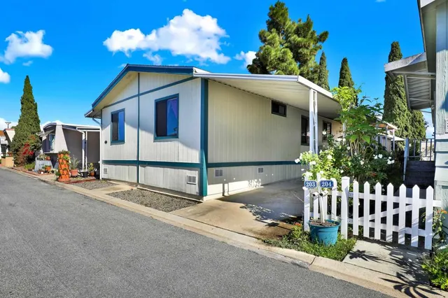 a front view of a house with plants