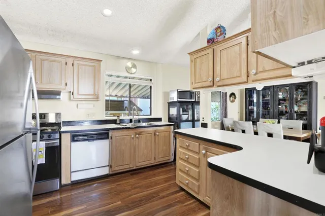 a kitchen with stainless steel appliances granite countertop a sink and cabinets