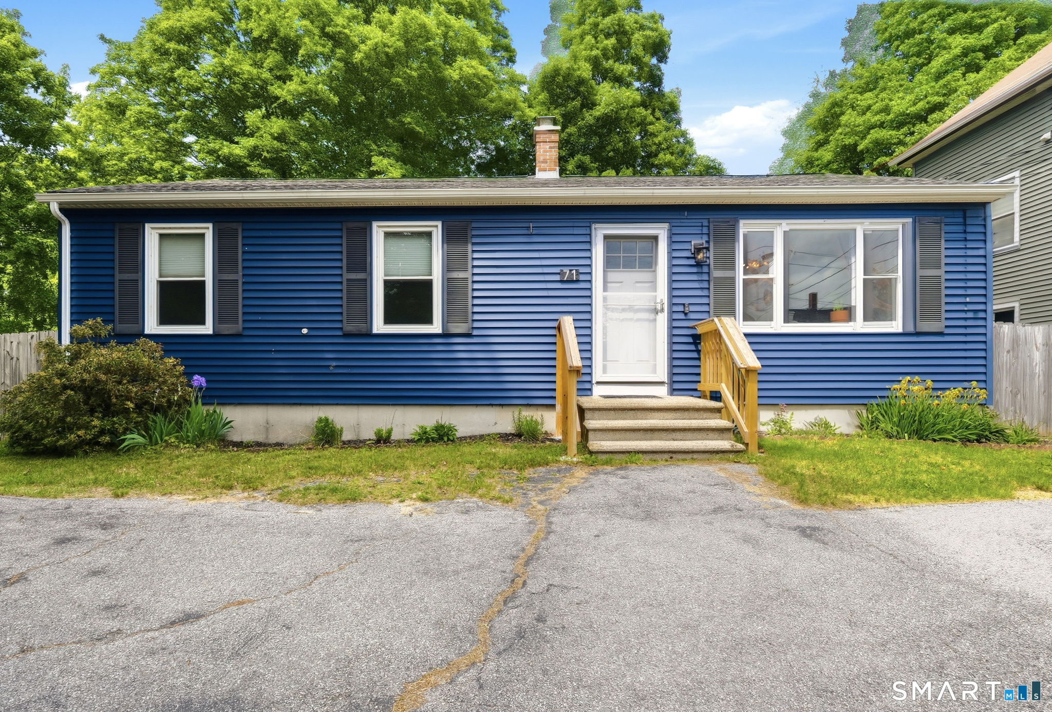 71 Smith Street Putnam, CT 06260 - Photo 1 of 25 a front view of a house with a yard