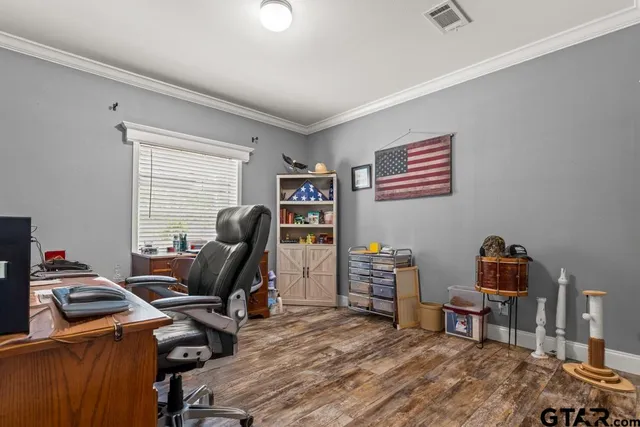 a living room with patio furniture and a wooden floor