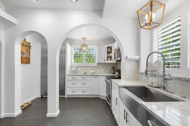 a kitchen with windows a sink and a window