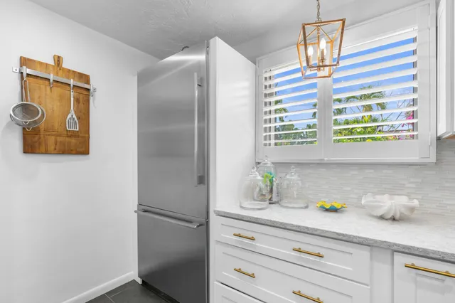 a kitchen with a refrigerator and a window