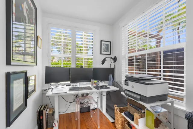 a view of a workspace with furniture and a window