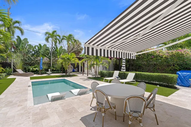 a view of a house with swimming pool and sitting area
