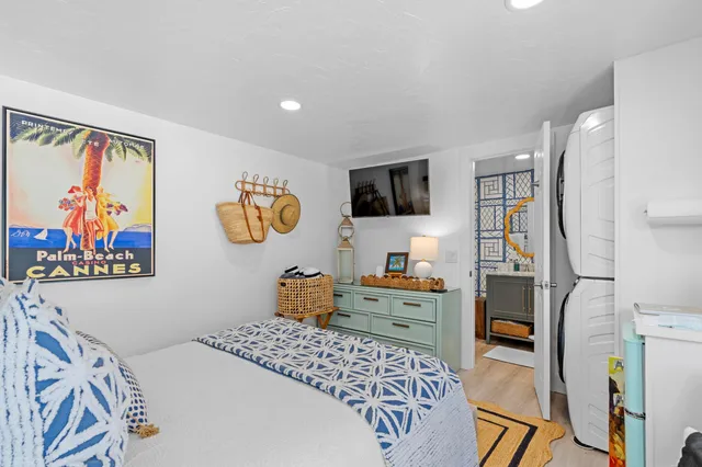 a bedroom with furniture and a flat screen tv