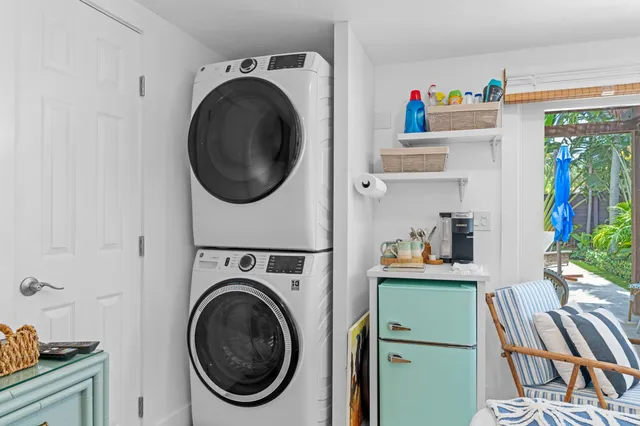 a utility room with sink dryer and washer