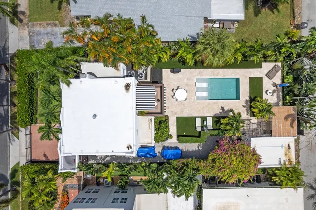 an aerial view of a house with a yard and garden
